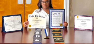 student displaying their certificates and achievements before graduation